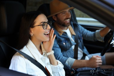 Happy couple enjoying trip together by car, selective focus