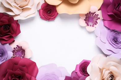 Photo of Frame of beautiful paper flowers on white background, flat lay. Space for text