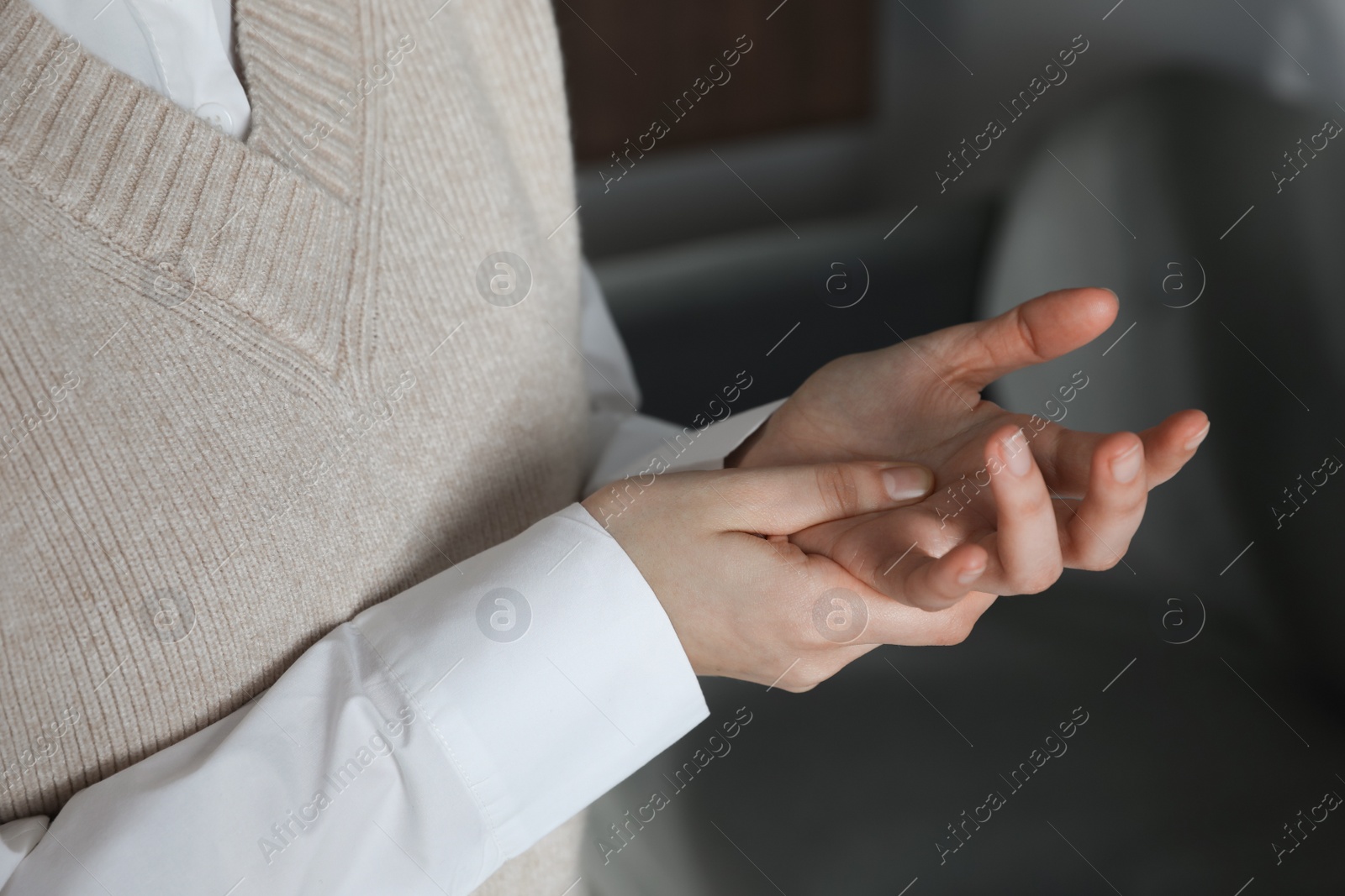 Photo of Woman suffering from trigger finger at home, closeup