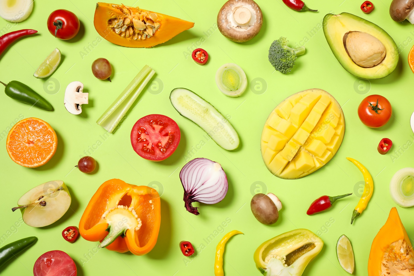 Photo of Flat lay composition with fresh organic fruits and vegetables on light green background