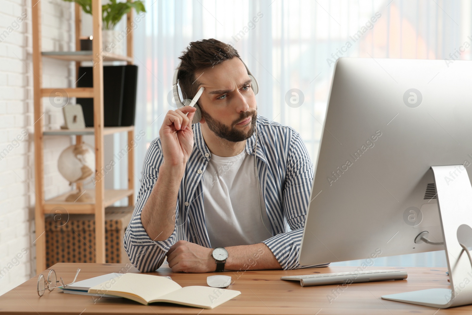 Photo of Online test. Man studying with computer at home