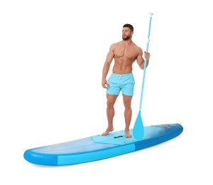 Photo of Handsome man with paddle on blue SUP board against white background