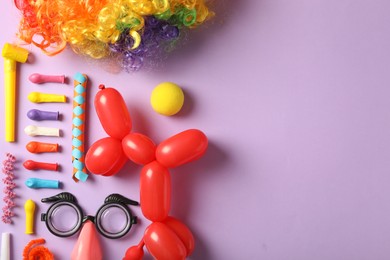Photo of Different clown's accessories on lilac background, flat lay. Space for text