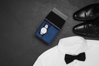 Photo of White shirt with bow tie, wristwatch and shoes on grey background, flat lay. Space for text