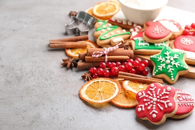 Photo of Composition with tasty homemade Christmas cookies on grey table. Space for text