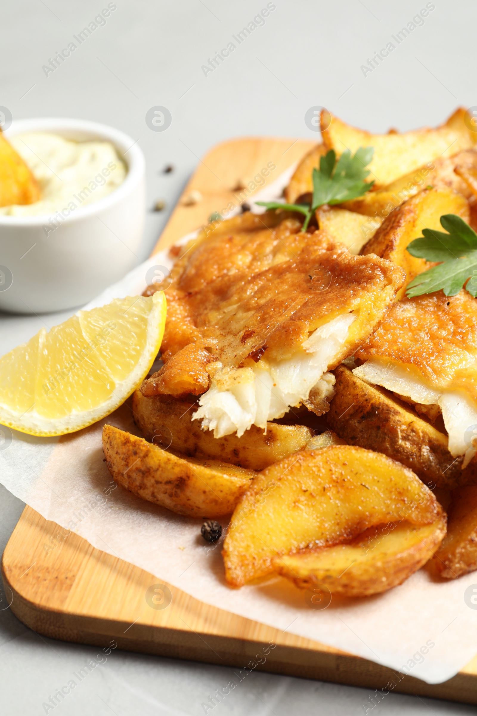 Photo of British traditional fish and potato chips on table