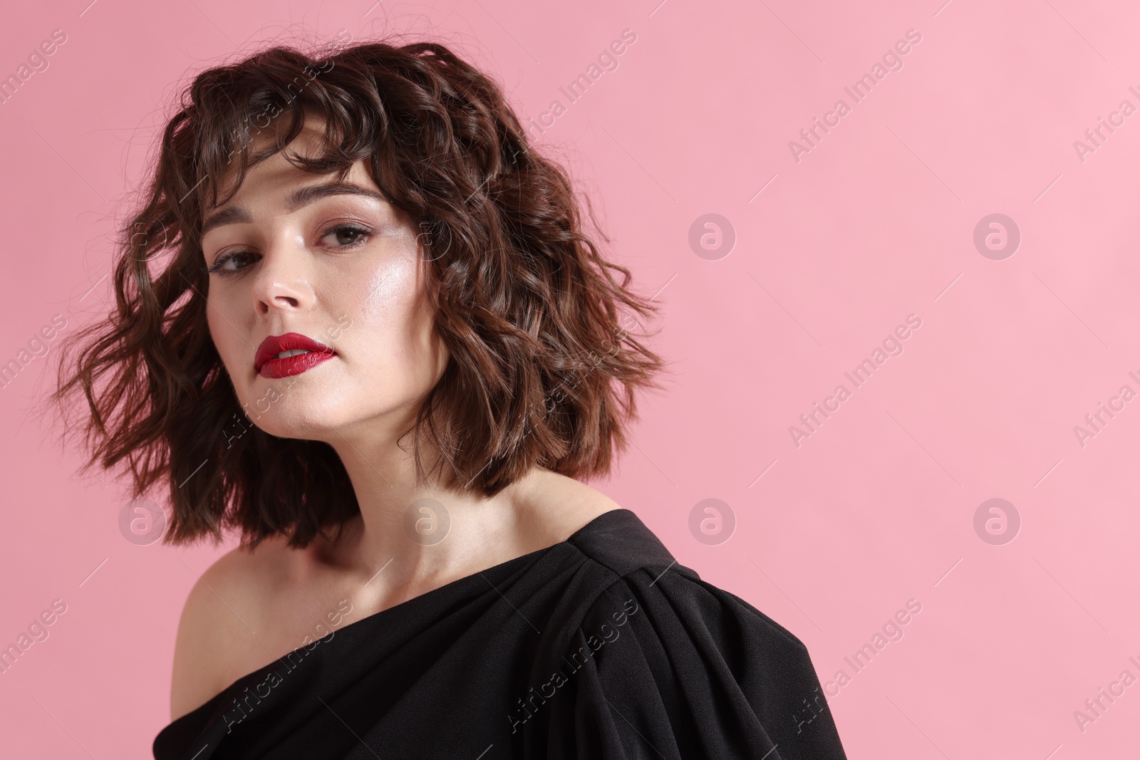 Photo of Portrait of beautiful young woman with wavy hairstyle on pink background. Space for text