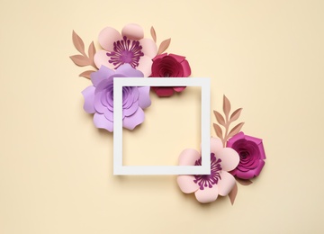 Photo of Different beautiful flowers made of paper and frame on beige background, flat lay. Space for text