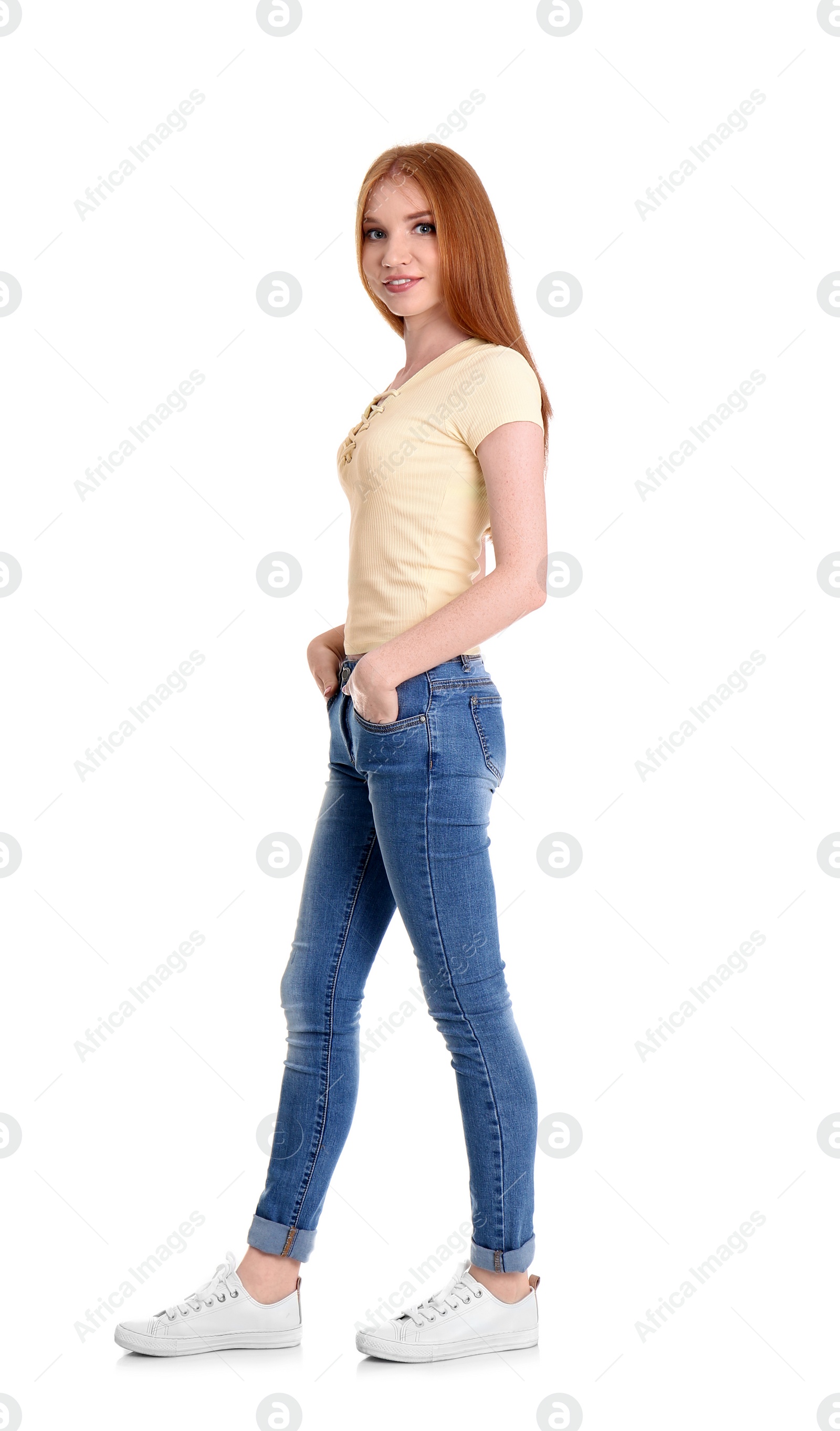 Photo of Young woman in stylish jeans on white background