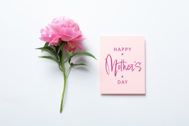 Image of Happy Mother's Day greeting card and beautiful peony flower on white background, flat lay