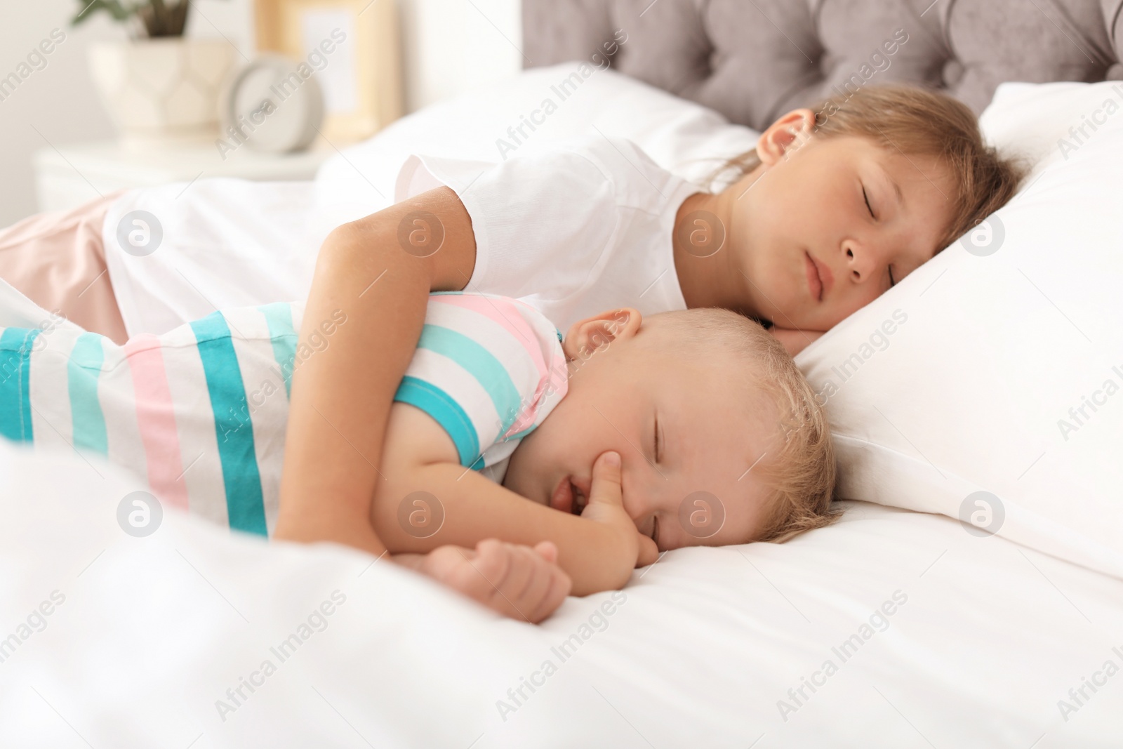 Photo of Little children sleeping in bed at home