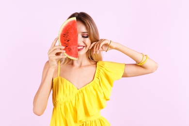 Photo of Pretty young woman with juicy watermelon on color background