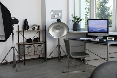 Professional lighting equipment and comfortable workplace in photo studio. Interior design