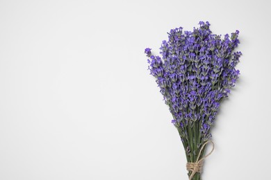 Photo of Bunch of aromatic lavender flowers on white background, top view. Space for text