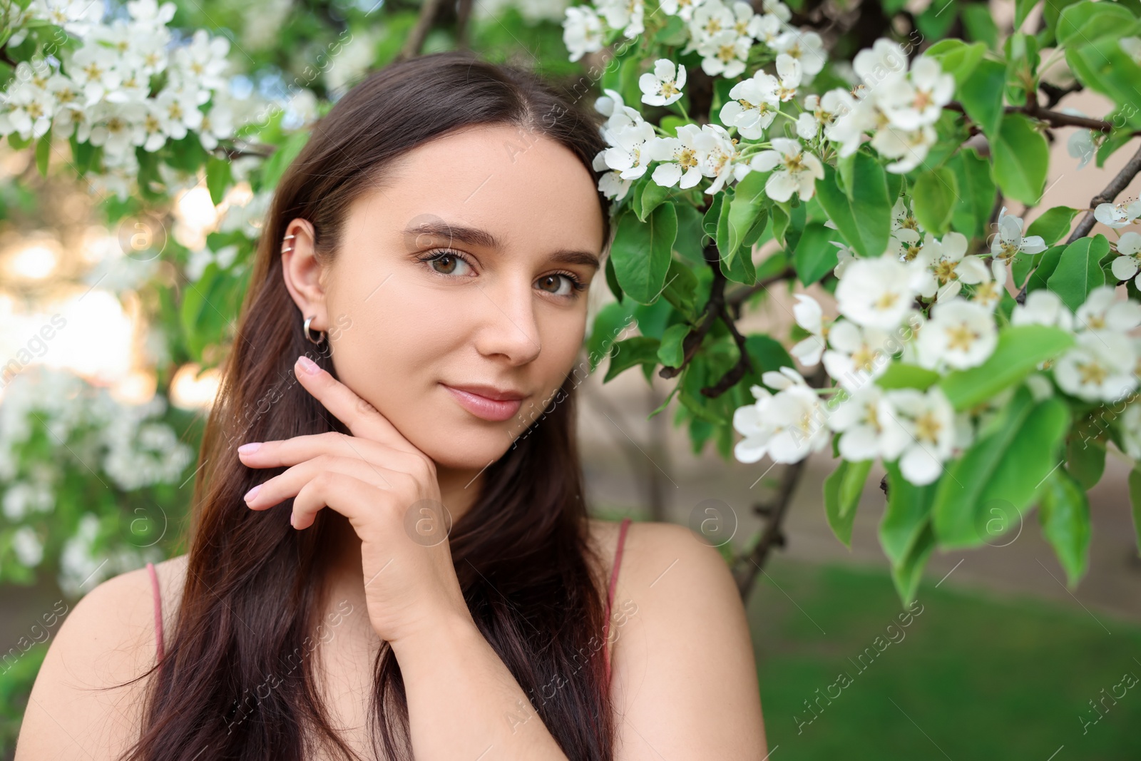 Photo of Beautiful woman near blossoming tree on spring day