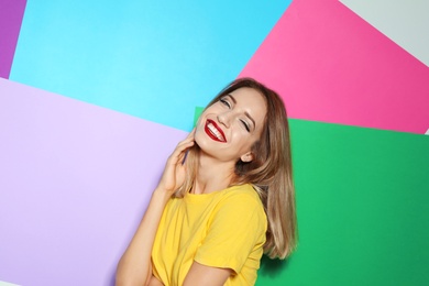 Photo of Beautiful young woman with healthy long blonde hair on color background