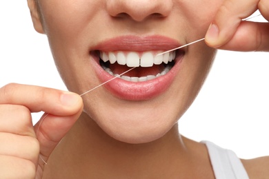 Photo of Young woman flossing her teeth on white background, closeup. Cosmetic dentistry
