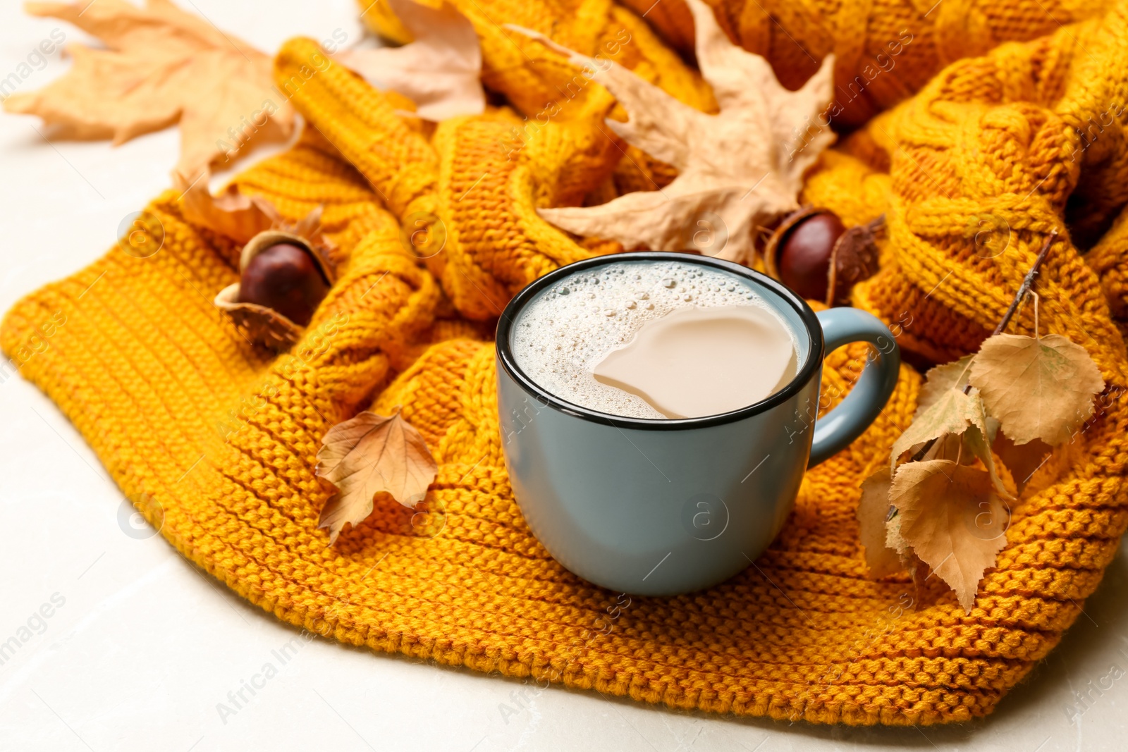 Photo of Composition with hot coffee warm plaid on light marble table, closeup