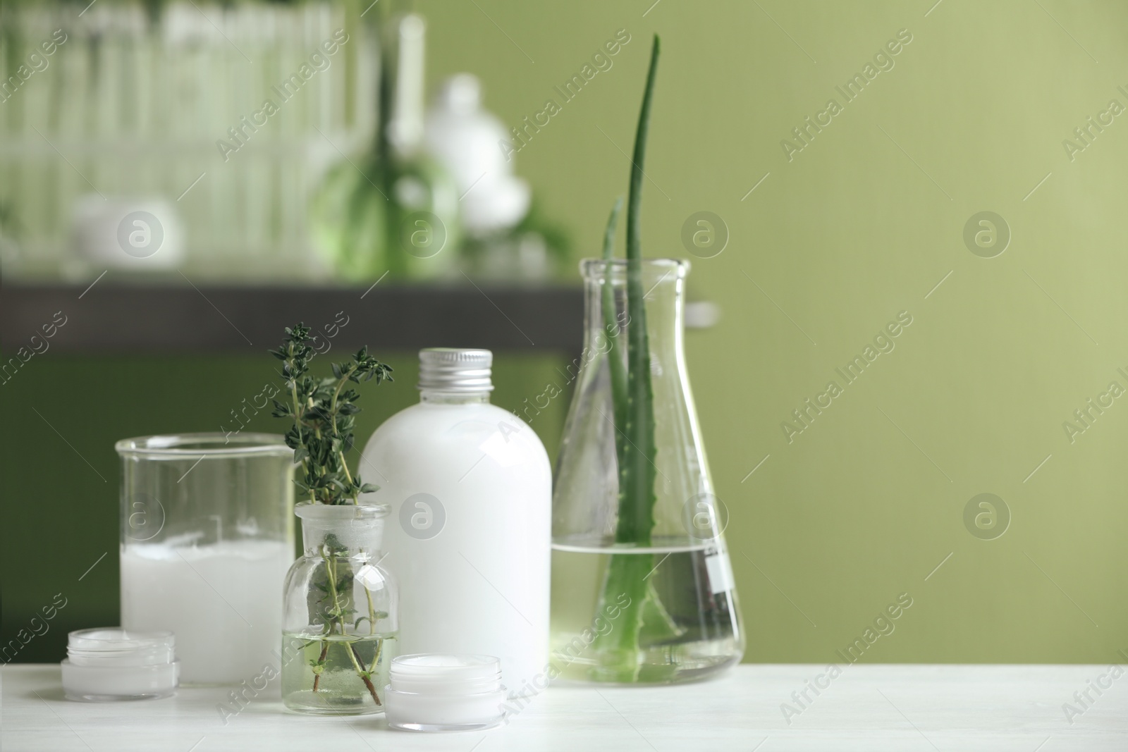 Photo of Composition with herbal cosmetic products and ingredients in laboratory, space for text