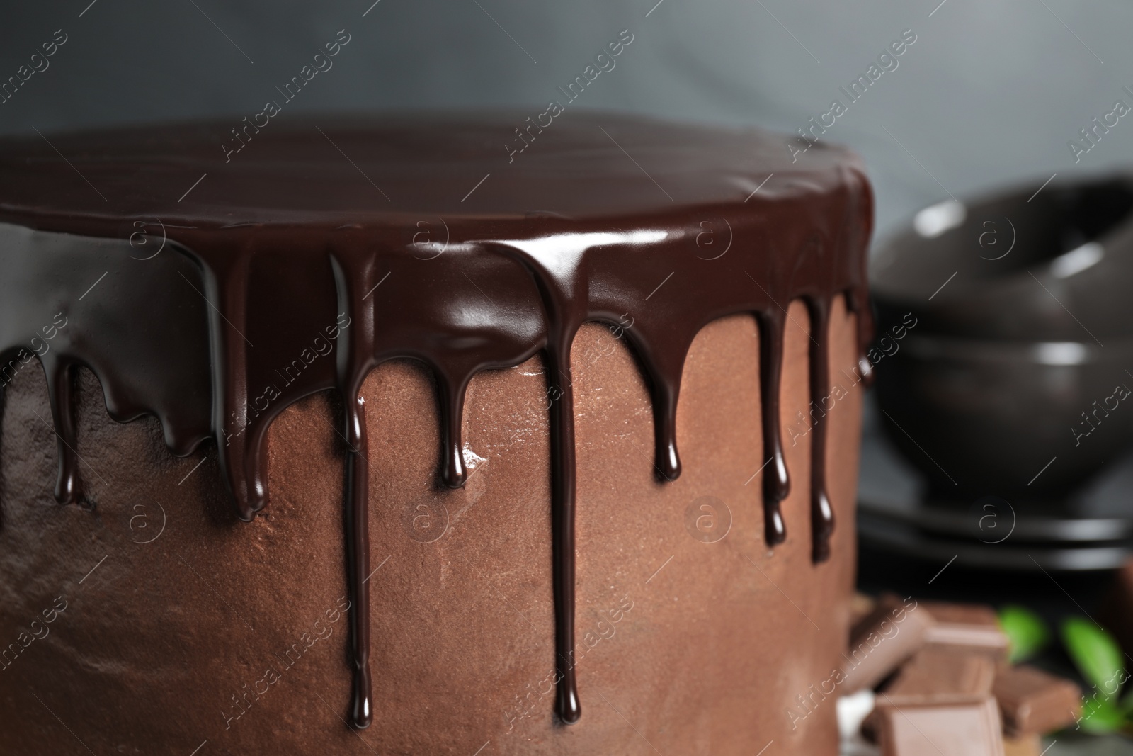 Photo of Freshly made delicious chocolate cake against grey background, closeup