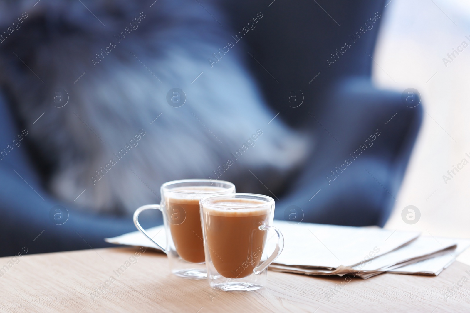 Photo of Cups of coffee and papers on table
