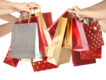 Image of Women holding paper shopping bags on white background, closeup