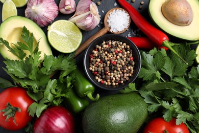 Fresh ingredients for guacamole on black table, flat lay