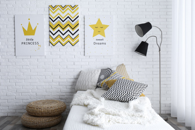 Photo of Child's room interior with bed and cute posters on wall