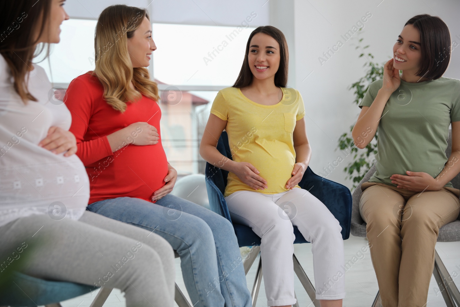 Photo of Group of pregnant women at courses for expectant mothers indoors