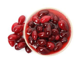 Photo of Delicious dogwood jam with berries on white background, top view