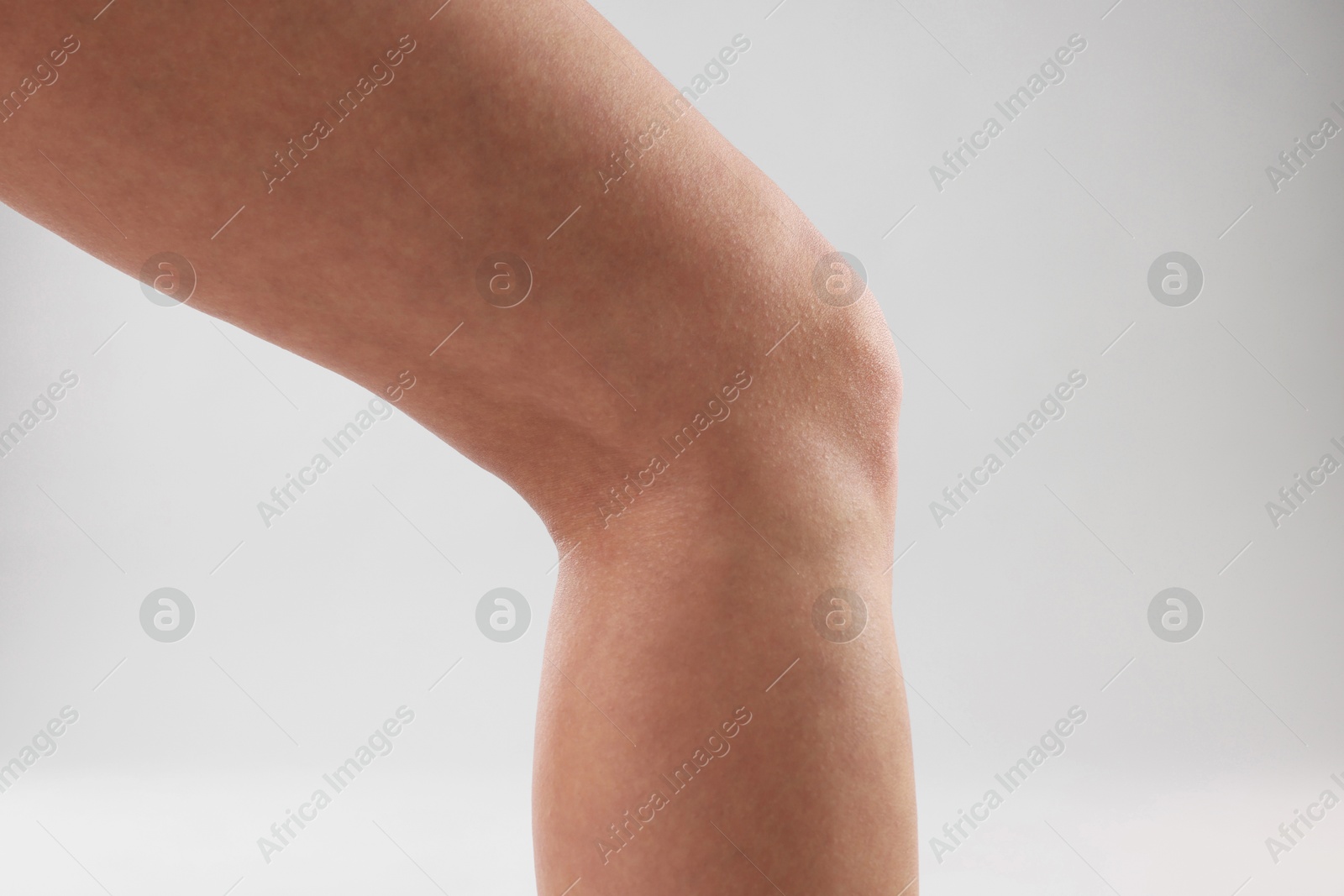 Photo of Woman with slim legs on grey background, closeup