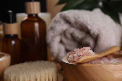 Photo of Spa composition. Pink sea salt, brush and bottles, closeup