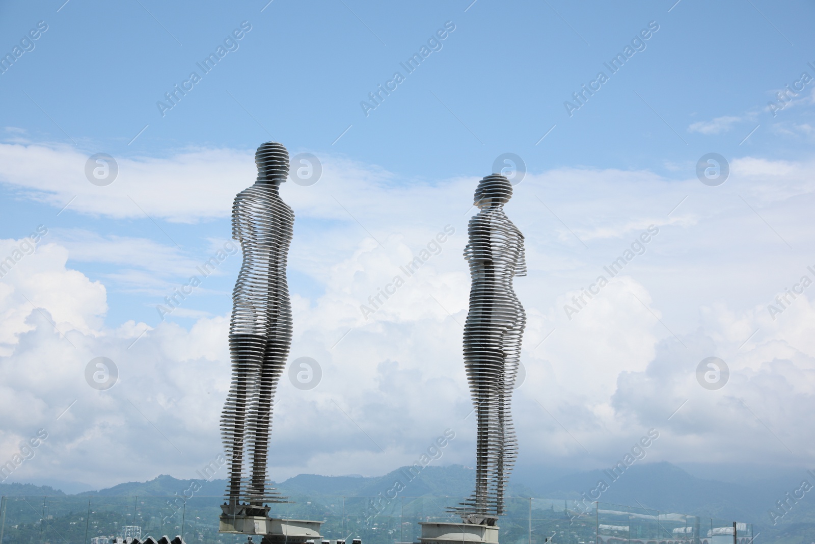 Photo of BATUMI, GEORGIA - JUNE 14, 2022: Movable sculptural composition Ali and Nino with breathtaking landscape on background