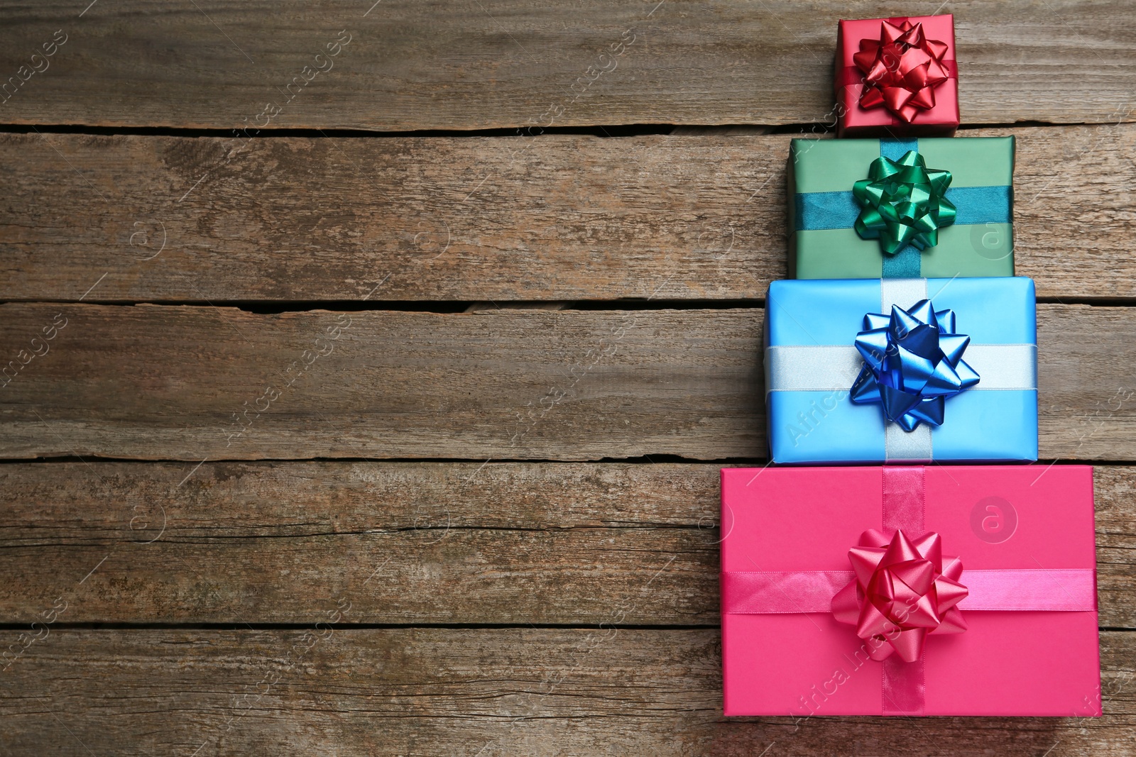 Photo of Many colorful gift boxes on wooden table, flat lay. Space for text