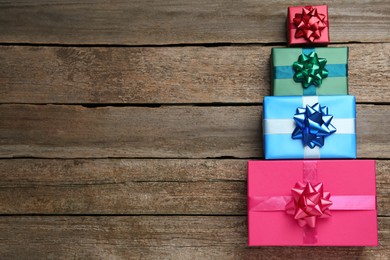 Photo of Many colorful gift boxes on wooden table, flat lay. Space for text