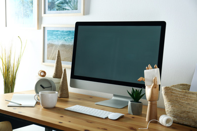 Photo of Modern computer and office supplies on wooden table, space for text. Designer's workplace