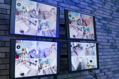 Photo of Modern monitors with video broadcasting from security cameras indoors. Safeguard's workplace