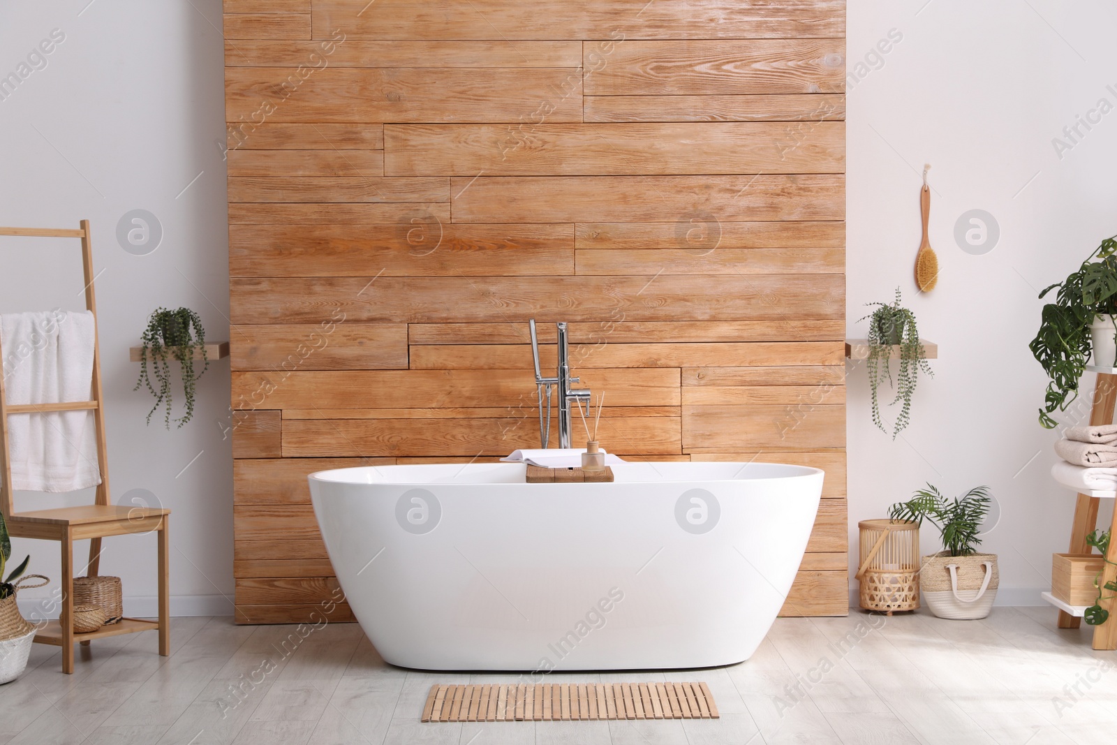 Photo of White tub and beautiful plants in bathroom, Interior design