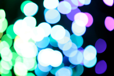 Photo of Blurred view of colorful lights on black background. Bokeh effect