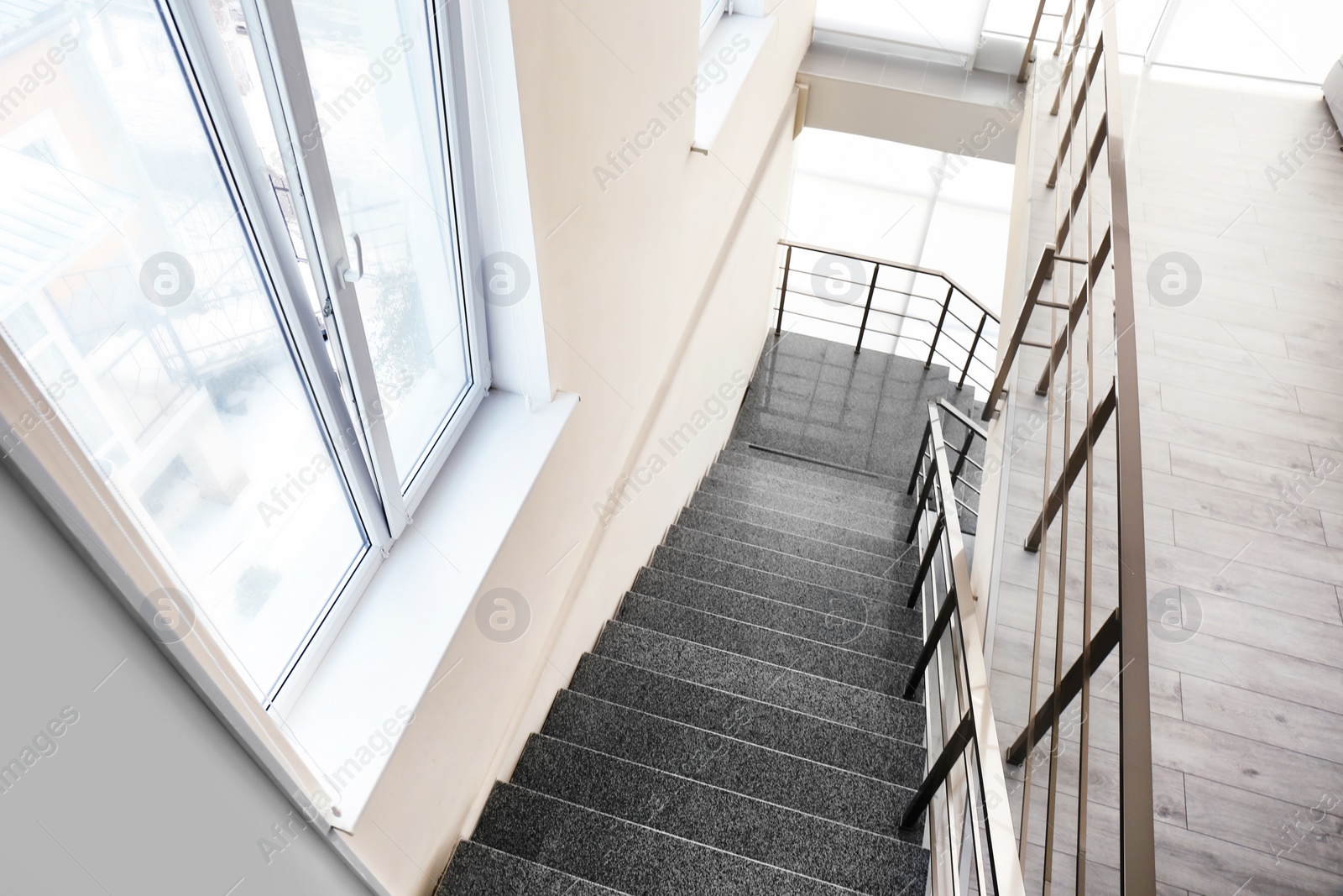 Photo of Stone stairs with metal railing indoors, view through CCTV camera