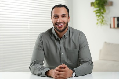 Photo of Young man having online video call at home, view from camera