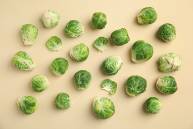 Photo of Fresh Brussels sprouts on beige background, flat lay
