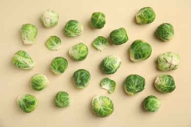 Fresh Brussels sprouts on beige background, flat lay