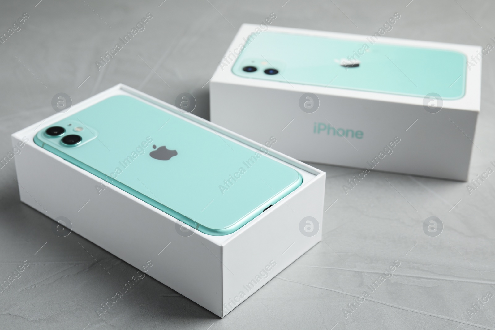 Photo of MYKOLAIV, UKRAINE - JULY 10, 2020: New modern Iphone 11 Green in original box on light grey table