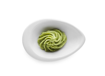 Photo of Bowl with swirl of wasabi paste isolated on white, top view