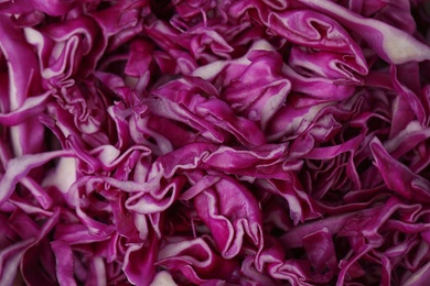 Photo of Shredded red cabbage as background, closeup view