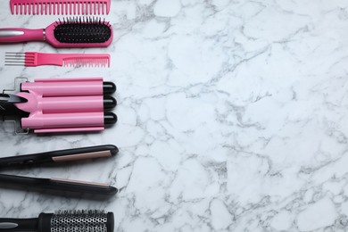 Photo of Flat lay composition of professional hairdresser tools on white marble table, space for text