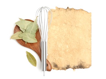 Photo of Old cookbook page, spice and kitchen utensils on white background, top view. Space for text