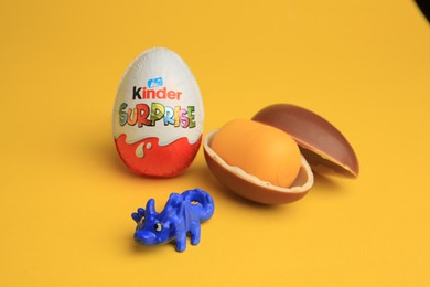 Sveti Vlas, Bulgaria - July 3, 2023: Kinder Surprise Eggs, plastic capsule and toy on yellow background