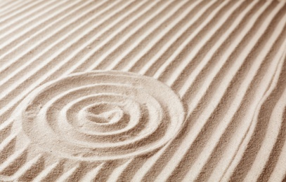 Photo of Zen garden pattern on sand. Meditation and harmony